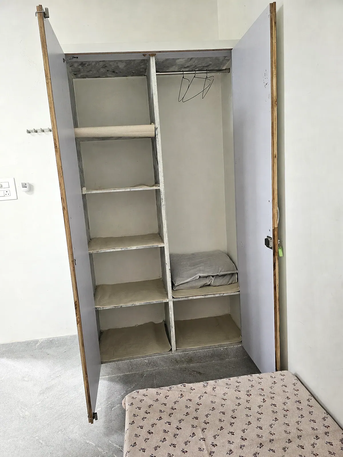 Open wardrobe showing shelves and hanging storage in the representative room